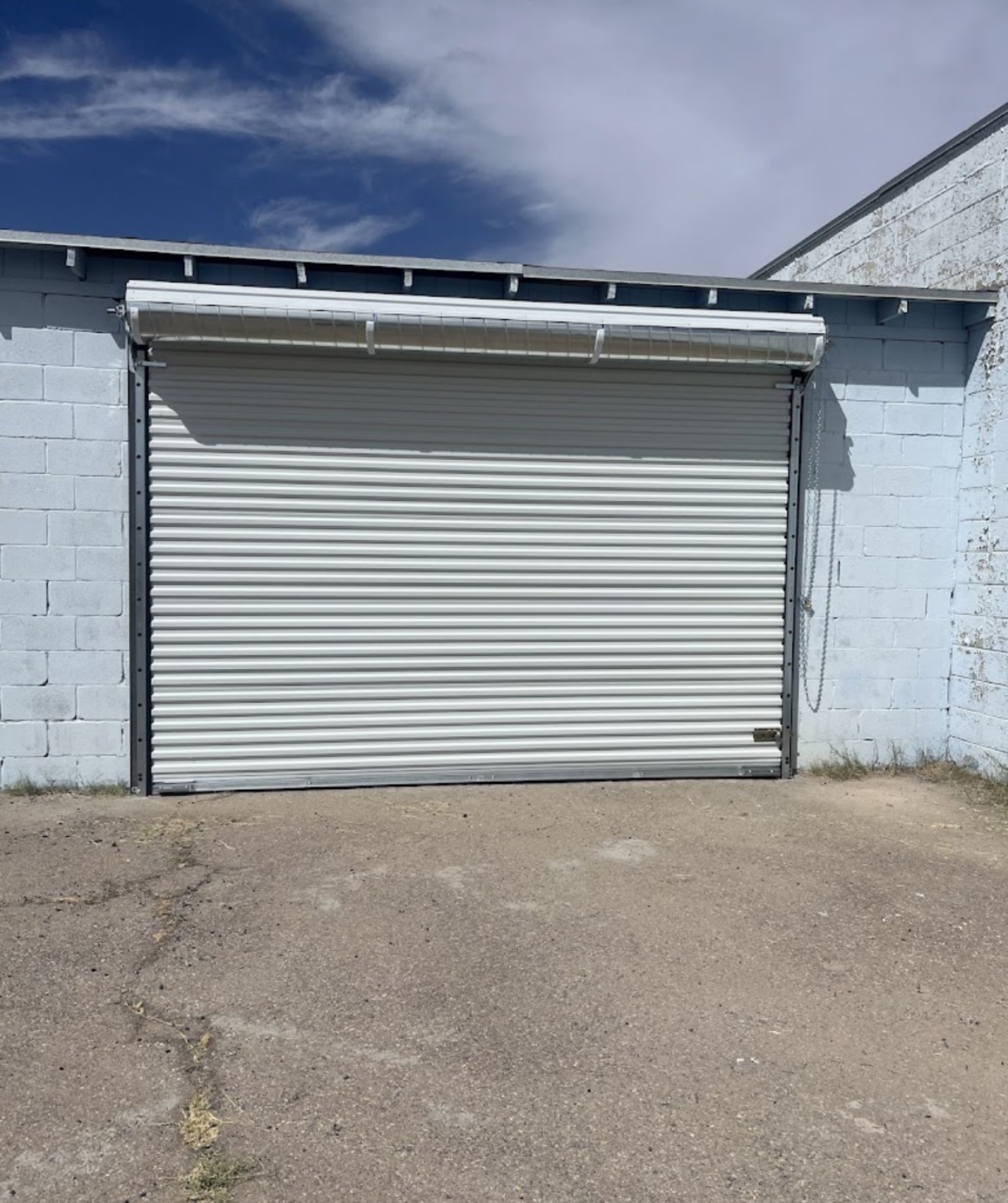 Commercial roll-up door installed on a block building